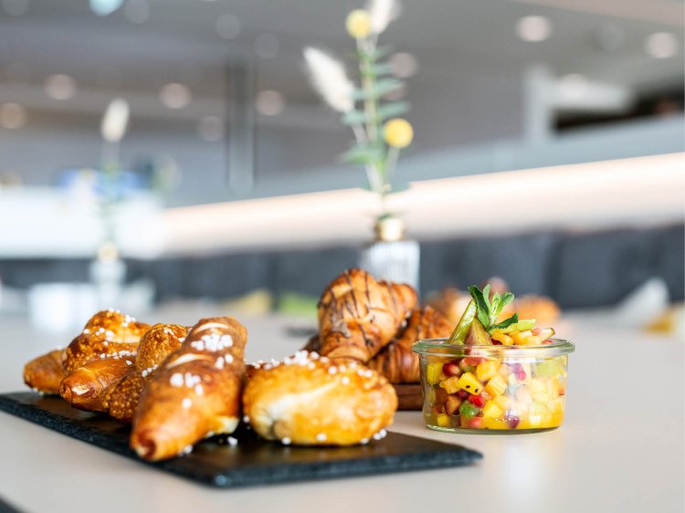 Ein gedeckter Tisch mit Kaffee- und Teestation, frischem Obst und Gebäck für eine Kaffeepause im Hotel Schloss Montabaur.
