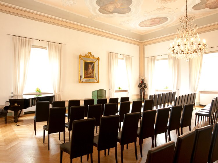 Magnificent Knights' Hall at Hotel Schloss Montabaur with elaborate ceiling paintings, banquet seating and a festive ambience for up to 72 guests