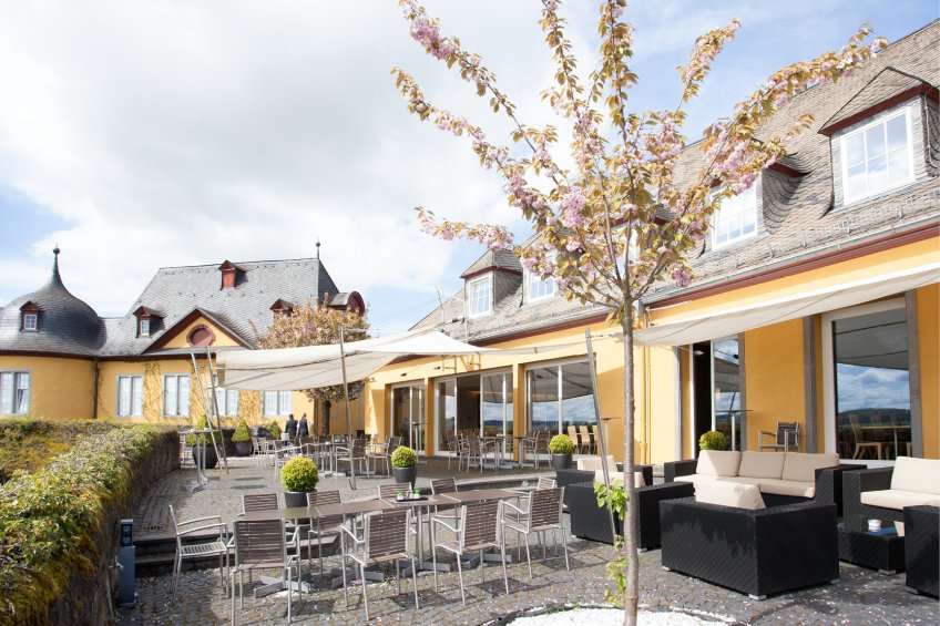 Exterior view of Hotel Schloss Montabaur with castle grounds, green parkland and historical flair